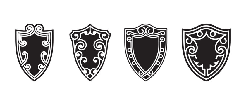 Set of four decorative black shields with elegant vintage swirl patterns and classic heraldic shapes for design elements.
