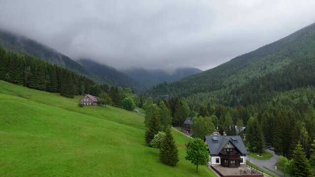 Aerial view of mountain valley with spruce forest and village in Krkono&scaron;e Mountains Czech Republic in summer