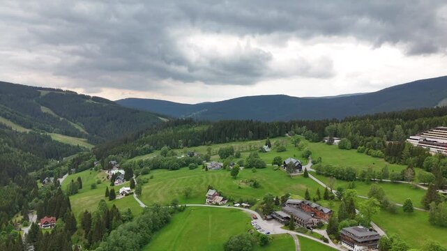 Aerial view of mountain house in misty spruce forest in Krkono&scaron;e Mountains Czech Republic