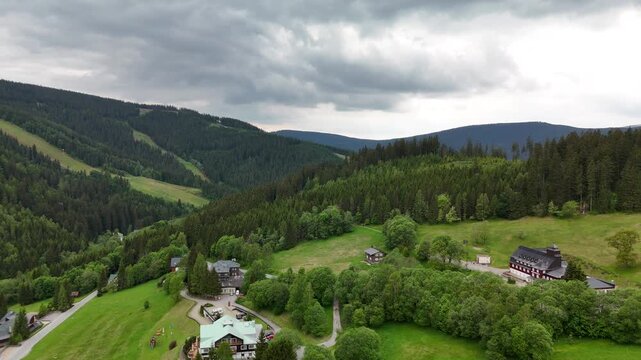Aerial view of mountain house in misty spruce forest in Krkono&scaron;e Mountains Czech Republic
