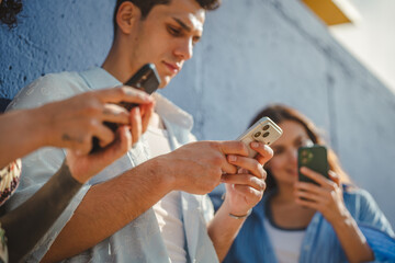Young people glued to smart phones connected to digital world