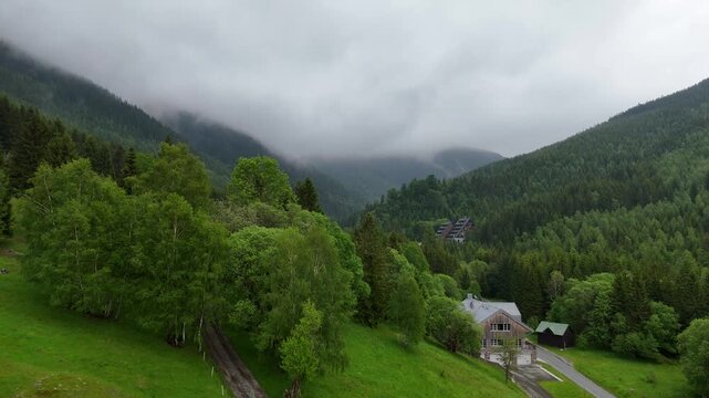 Aerial view of mountain house in misty spruce forest in Krkono&scaron;e Mountains Czech Republic