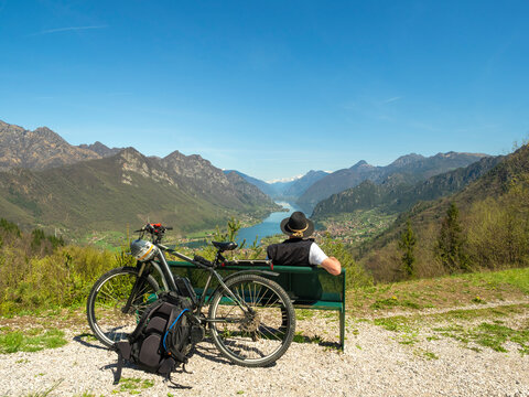Italy, Lombardy, Senior hiker looking over Idro lake, Adamello Alps, Parco Naturale Adamello Brenta