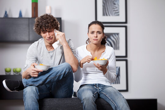 Germany, Bavaria, Young couple watching TV
