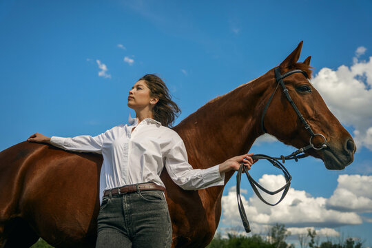 Woman and horse, serene outdoor moment