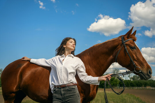 Woman and horse, serene outdoor moment