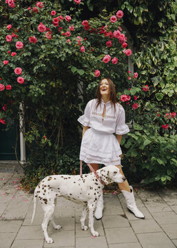 woman with dalmatian dog on the leash on the street in Amsterdam
