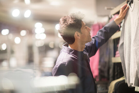Man choosing clothes in shop