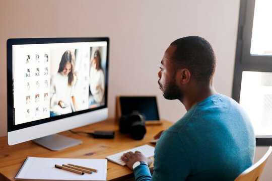 Young photographer editing images at desk