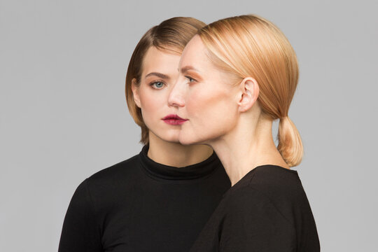 Studio portrait of mother and adult daughter