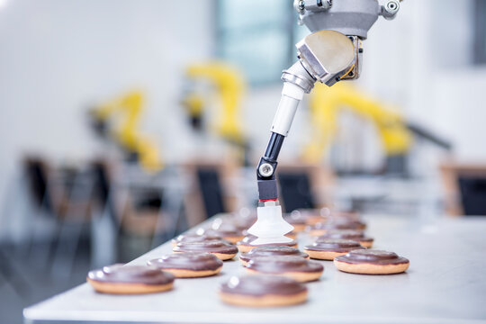 Close-up of industrial robot handling cookies