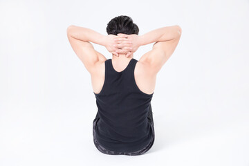 Obraz premium Rear view of fit man doing sit ups on white background