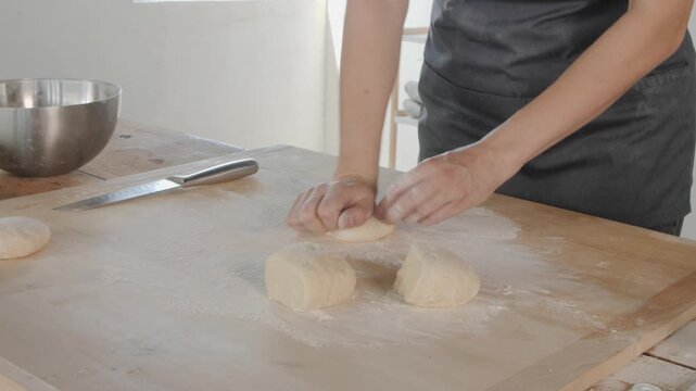 Woman's hands kneading and shaping bread dough