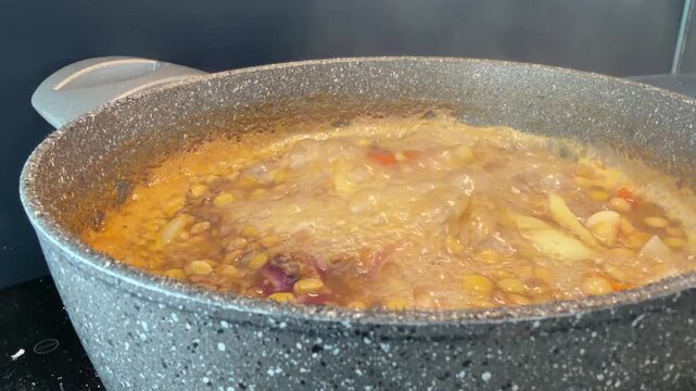 Home Cooked Pot of Steaming Lentil Soup for Whole Foods and Natural Eating Concept