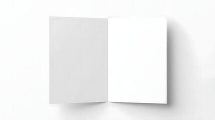 Naklejka premium Open blank brochure or booklet with clean white pages on a light gray background, top view