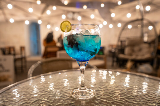 Exotic luxury cocktail served in a unique glass at an upscale night bar