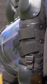 Security forces in shields and armor during march. Coordination public safety under democratic rights. Protect participants while allowing freedom of assembly during civic action