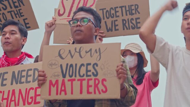 Passionate demonstrators raising placards with messages participating in vocal rally