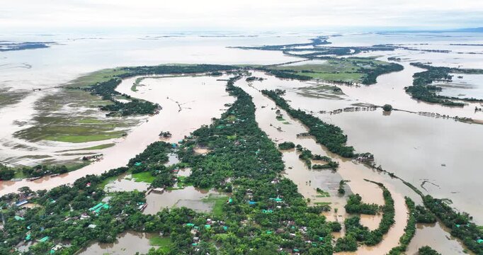 Aerial view of Tanguar Haor wetland with flooded villages and lush green trees under an overcast sky in Sunamganj District, Sylhet Division, Bangladesh.