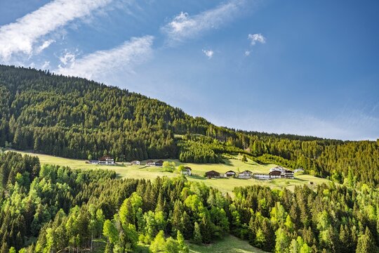 Traditional Tyrolean Houses Nested in Lush Green Alpine Landscape, Picturesque Mountain Village in K&uuml;htai Valley, Austria