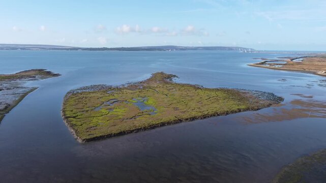 Aerial Drone Footage Over Lymington Salt Marshes with Isle of Wight Horizon, Hampshire UK Coast