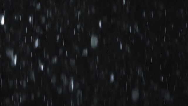 Abstract background of shimmering white particles against a dark, blurred backdrop, suggesting a cosmic or ethereal atmosphere.