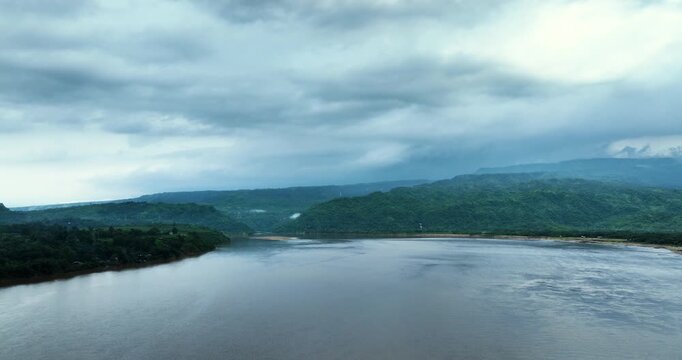 Aerial view of Tanguar Haor wetland with lush green hills under a cloudy sky in Sunamganj District, Sylhet Division, Bangladesh.