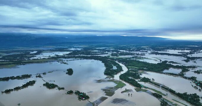 Aerial view of Tanguar Haor wetlands with flooded plains and scattered vegetation under a cloudy sky in Sunamganj District, Sylhet Division, Bangladesh.