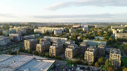 Obraz premium Drone view of city apartments and streets in sunny evening