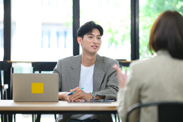 Young Asian Male Manager Conducting Job Interview with Candidate in Modern Office