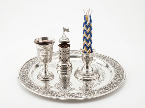 Jewish ceremonial objects on a silver plate isolated on white background