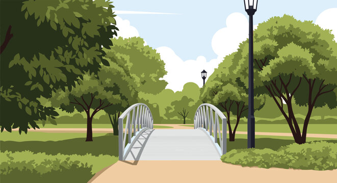 Beautiful public park scene features a small arched metal bridge over a path surrounded by lush green trees and lampposts.
