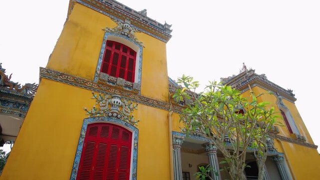Ornate yellow facade of Kien Trung Palace in hue, vietnam. Unesco world heritage site