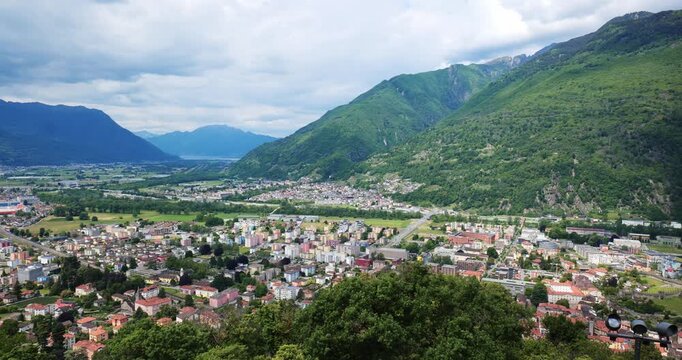 Bellinzona, Switzerland, May 18, 2026. Panoramic High Angle Panning Shot of the Alpine City and Medieval Castelgrande Castle