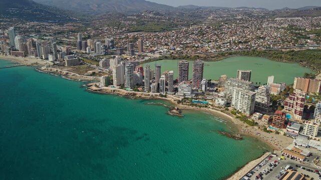 Aerial view of Calpe coastline turquoise bay skyline and salt lake in Spain