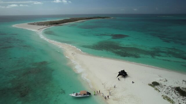 Luxury travel scene, drone over tourists enjoying Caribbean island beach, Cayo de Agua, Los Roques