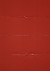 Fototapeta premium red matte photo paper texture featuring visible fold creases, subtle wrinkles, and realistic paper imperfections. The surface shows authentic folding marks and a slightly worn appearance.