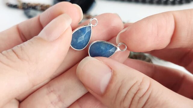 These refined blue teardrop pendants are encased in sleek silver frames offering a sophisticated and polished aesthetic for custom jewelry and elegant craft projects