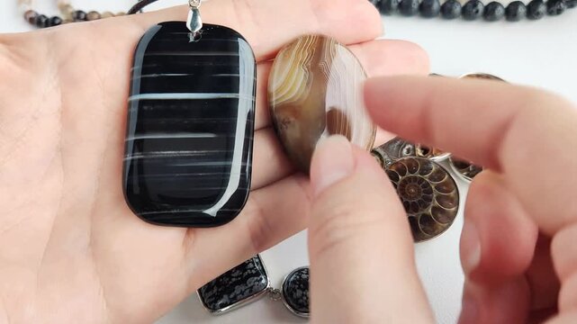 The large oval banded agate pendants feature smooth surfaces and unique swirling earth tone patterns that provide a refined and elegant aesthetic for custom jewelry and accessory design projects