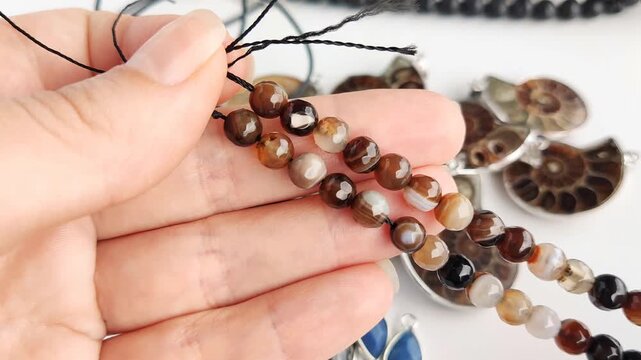 These assorted round agate beads showcase natural color variations and faceted finishes for sophisticated jewelry crafting and unique custom accessory design work