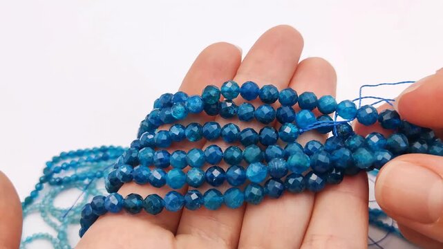 These vibrant blue apatite stone beads feature a multifaceted cut on durable stringing wire for creating elegant custom jewelry, professional artisan accessories, and intricate craft projects