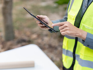 Asian engineer using tablet for digital monitoring and project management in engineering work. © Charlie's