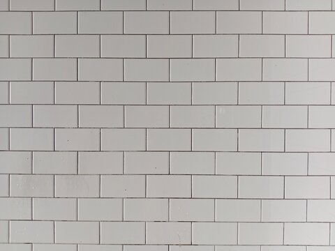 Clean white ceramic tiled wall surface