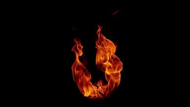 Small fire explosion with glowing sparks and embers isolated on a black background. Dynamic flames and combustion effects captured in high detail for dramatic visual impact.