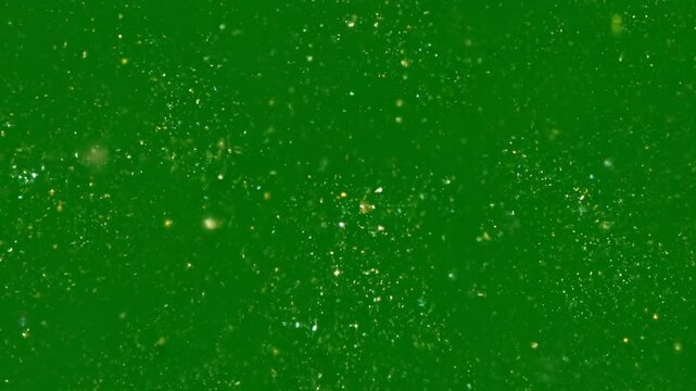 Explosion of golden light and sparkling particles emanates from a central point creating a dazzling starburst effect against a deep green background 4k Video