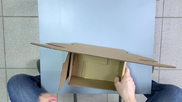 DIY box. Cardboard box. Table. Slow motion video. High quality 4k footage