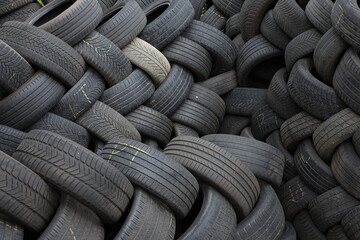 Close up of stacked used tires. Detailed view of worn vehicle tires stacked together in a storage area. © Photo Image 555