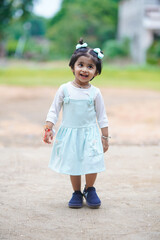 Fototapeta premium Cute indian little girl child posing outdoor