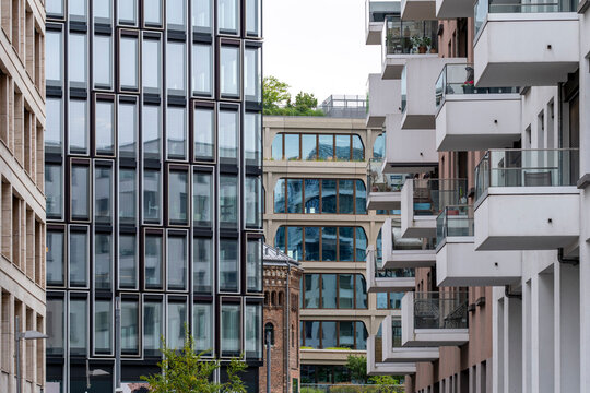 Urban layers in Berlin, Germany gather around a modern building facade where architecture, window grids, balcony edges, and courtyard density meet