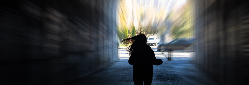 A girl fleeing from a chase, running quickly with urgency and fear, highlighting tension, danger, and dramatic movement.